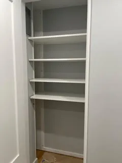Professionally designed closet storage system with hanging rods and drawers