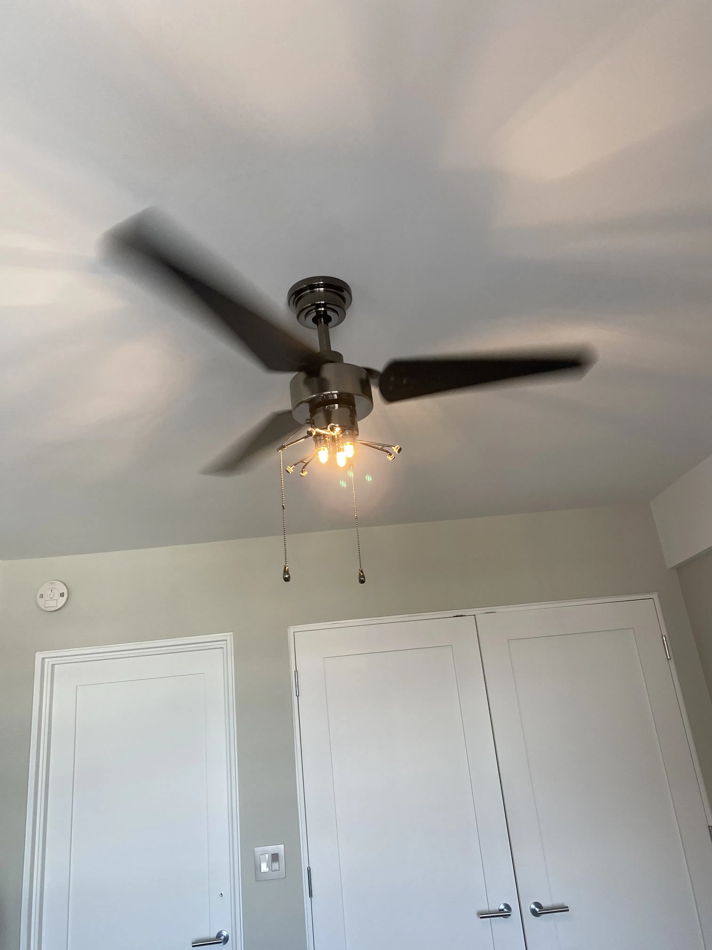 Renovated living space with modern ceiling fan and artwork